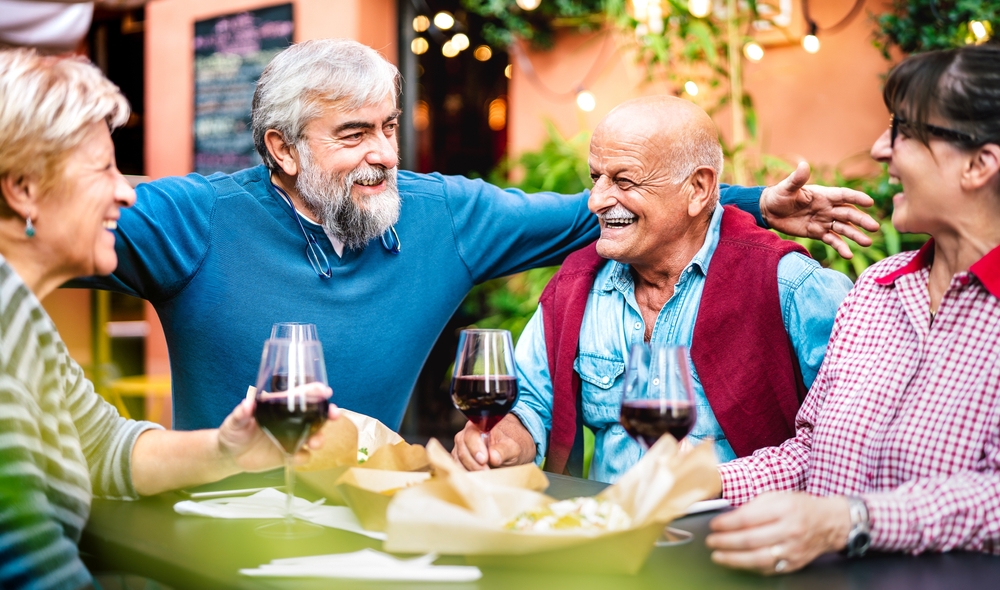Genuine,Retired,People,Having,Fun,Drinking,Red,Wine,At,Dinner